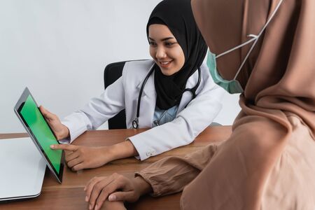 muslim doctor explaining to her patientの写真素材