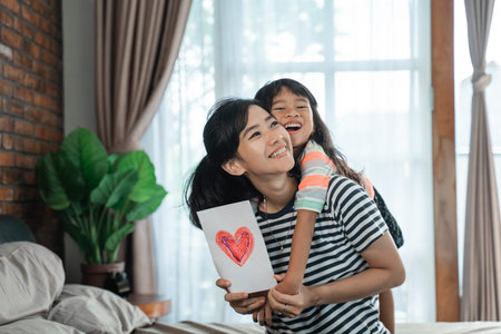asian child giving love letter to mother
