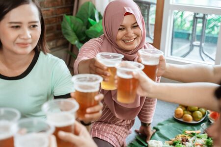 woman social gathering cheering their glass togetherの写真素材