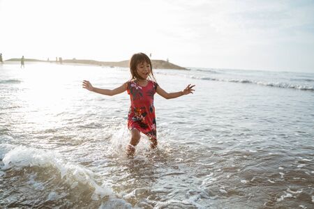 have fun little Asian girl runningの写真素材