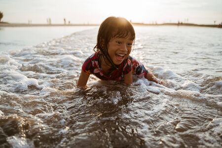 Little girl playing at the beachの写真素材