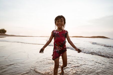 have fun little Asian girl runningの写真素材