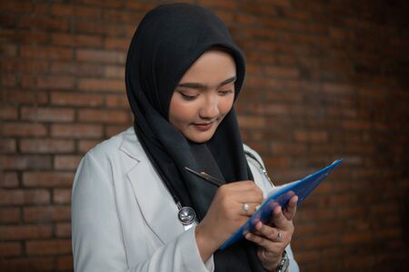 muslim doctor working at her clinicの写真素材