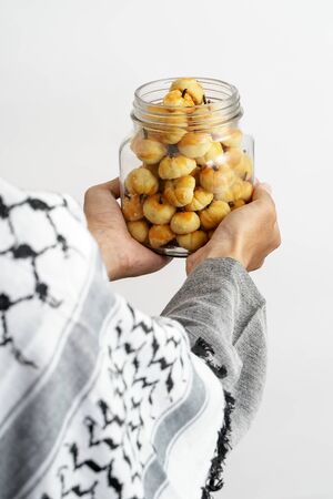 muslim hand gesture holding nastarの写真素材