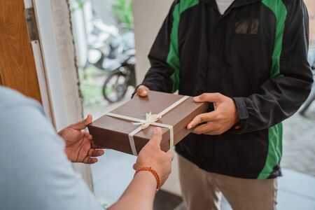 delivery  driver courier delivering gift boxの写真素材