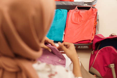 hand packing on a suitcaseの写真素材