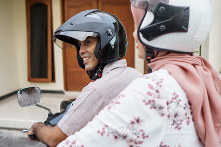 muslim woman and man riding motorcycle