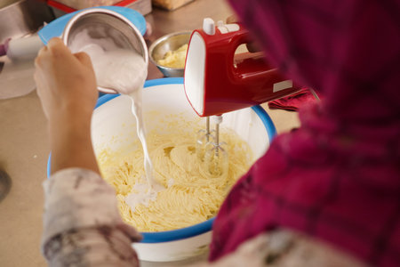 baking home made cake. dough being mix by mixerの写真素材