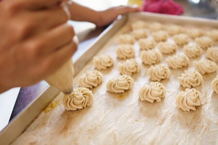 semprit cake. asian bite sized dessert. piping some dough kue sepiritの写真素材