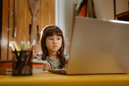 young kid learning by using laptopの写真素材