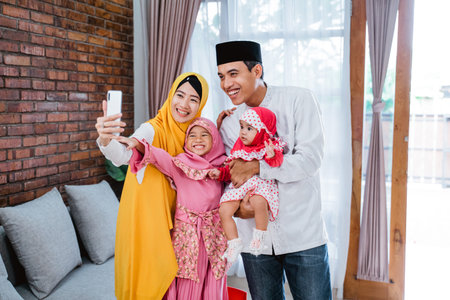 muslim family video calling with relatives during eid mubarakの写真素材