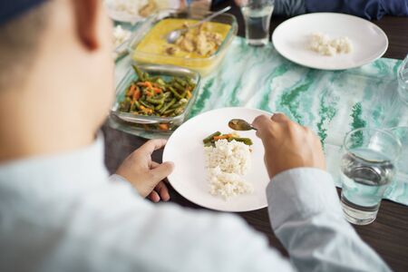 family muslim eating in dinner table togetherの写真素材