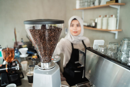 waitress holding a coffee grinder