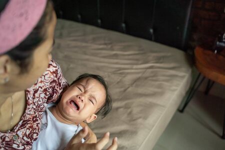 baby with swollen forehead after falling from bedの写真素材