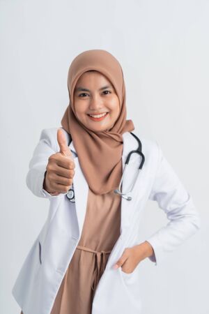 muslim doctor showing thumb up to cameraの写真素材
