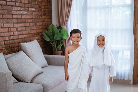 kid wearing muslim ihram clothes and dressの写真素材