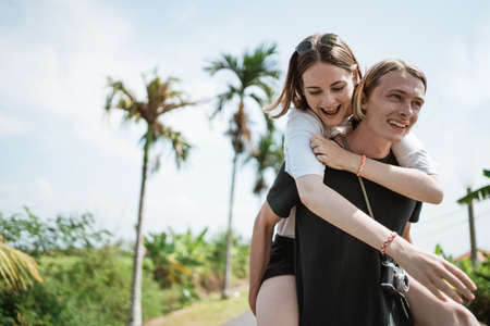 A man carrying his girlfriendの写真素材