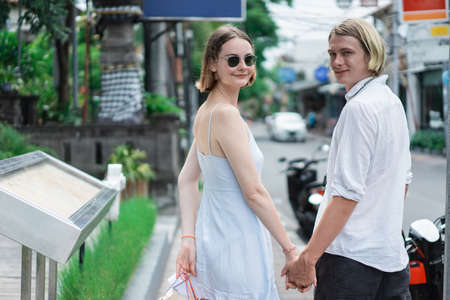summer holiday of a couple walking on shopping centre in asiaの写真素材