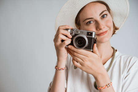 woman photographer going on vacation over white backgroundの写真素材