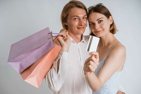 couple with shopping bag and holding a credit cardの写真素材