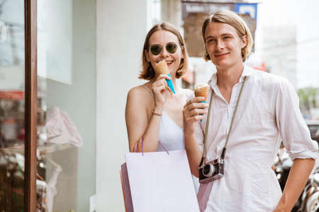 summer holiday of a couple walking on shopping centre in asiaの写真素材