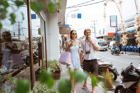 summer holiday of a couple walking on shopping centre in asiaの写真素材