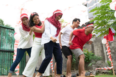 two groups of participants tried to run during the traditional bakiak race on Indonesias Independence Day celebrationの写真素材