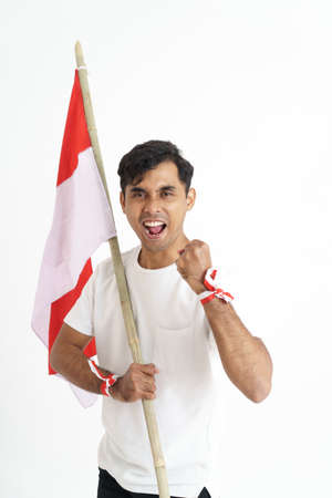 excited male holding indonesian flagの写真素材