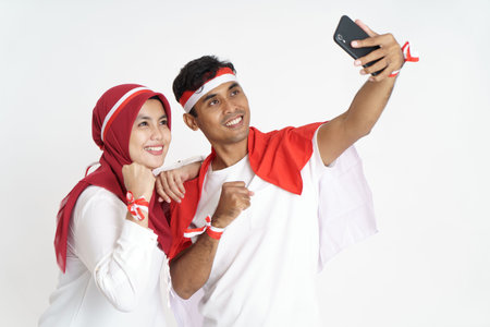 happy couple with indonesian flag taking selfie togetherの写真素材