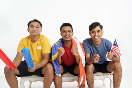 male supporter holding malaysia flag