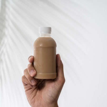 hand holding plastic bottle product mockupの写真素材