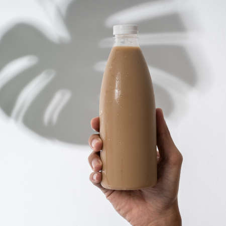 hand holding plastic bottle product mockupの写真素材