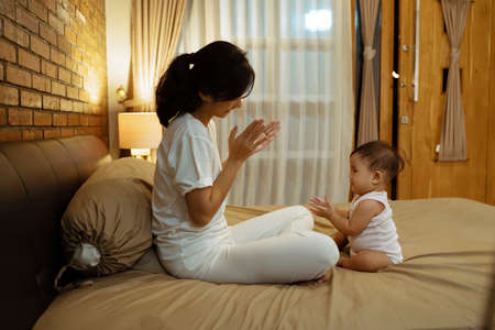 Portrait of mother and baby playing and smilingの写真素材