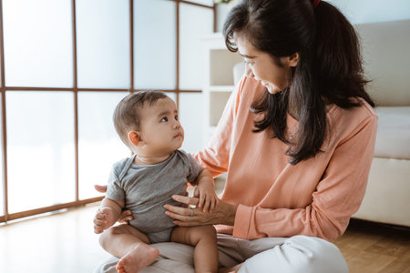 mother playing with her baby at home