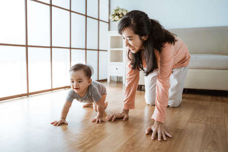 mother playing with her baby at homeの写真素材