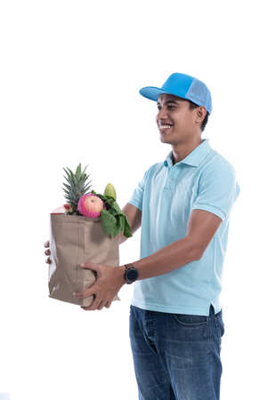 online courier carrying groceriesの写真素材