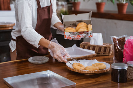 Close up of Hand Woman preparing homemade donuts in her kitchenの写真素材