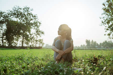 a beautiful young girl was sitting looking sidewaysの写真素材