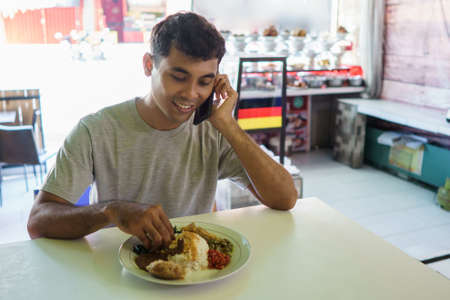 a man enjoying traditional foodの写真素材
