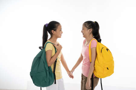 two couple student meet friend carrying bag and books in casual clothesの写真素材