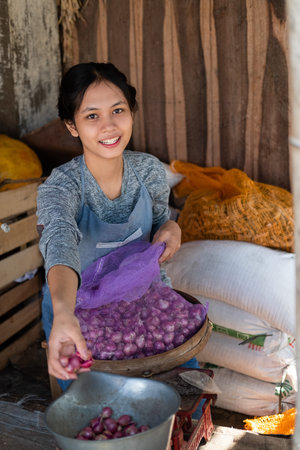 greengrocer smiled as he weighed the shallots on traditional scales