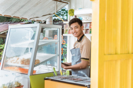 asian man small business owner at his shop made of truck container