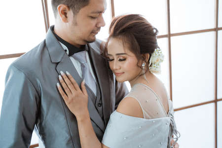 Close up men and women wearing wedding dresses and suits. Couple photo conceptの写真素材