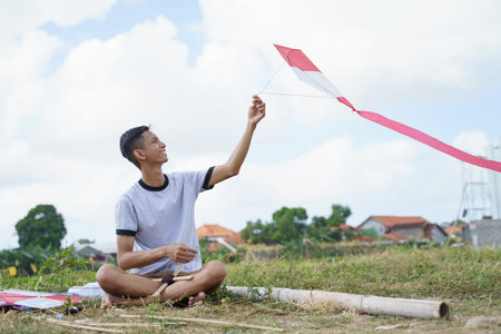 young man makes a kite weight rope