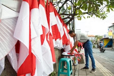 portrait of a young man folding flags