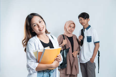 Three asian students close up background.の写真素材