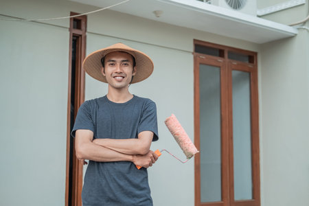 Painters wear caps with crossed hands holding paint rollers