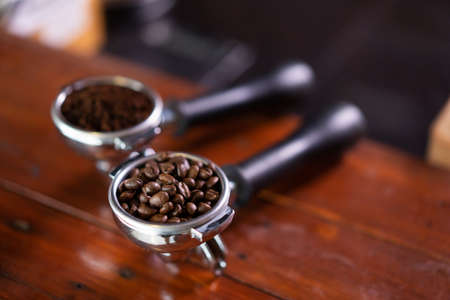 showing two fresh coffee beans on a tableの写真素材