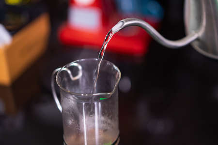 closeup barista pour water into a cup.の写真素材