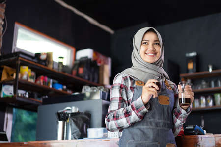 close up of female waitress holding coffee.の写真素材